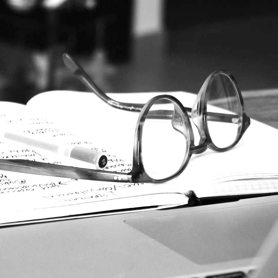 eyeglasses with gray frames on the top of notebook