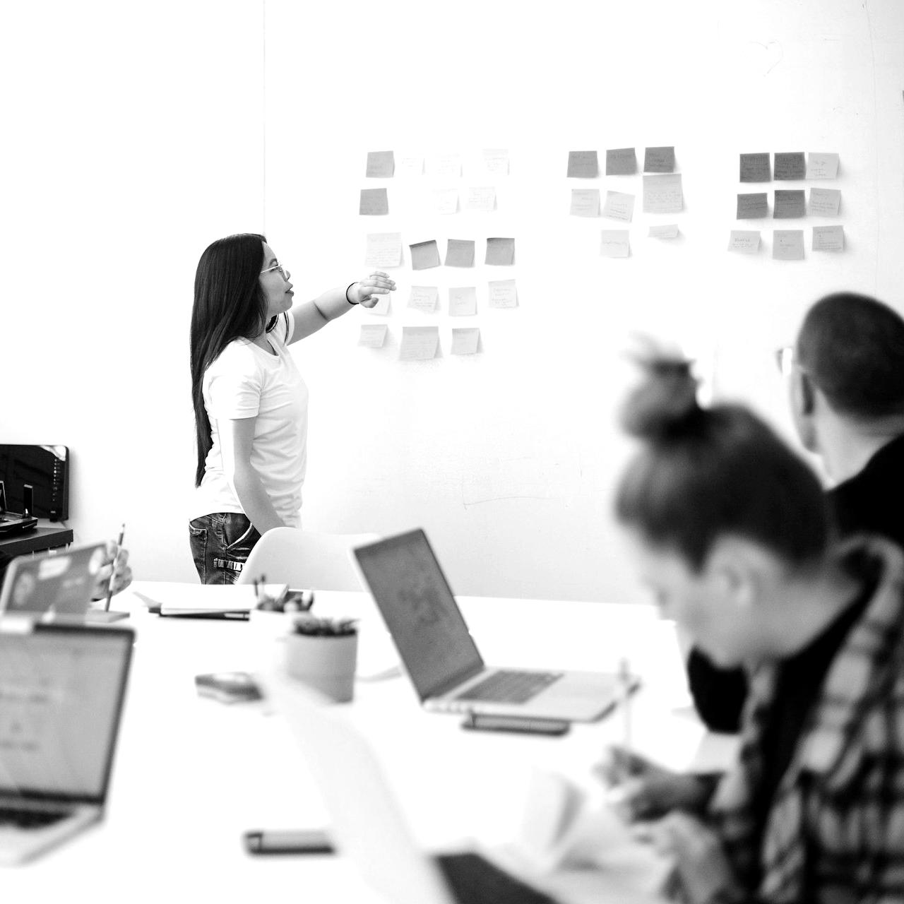 woman placing sticky notes on wall